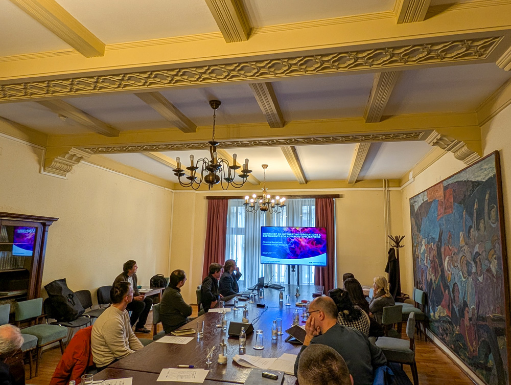 People sitting around a table and watching a presentation