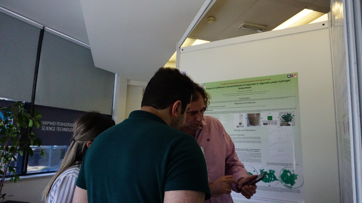 conference participants discussing a poster presentation